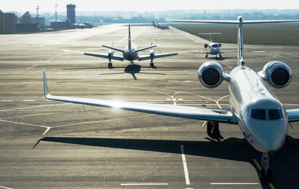 Private jet planes stand on the landing line.